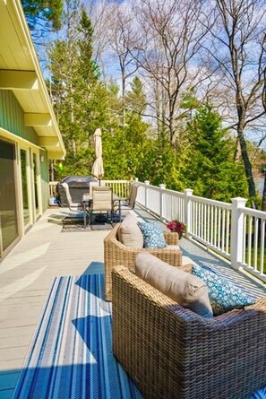 Large outdoor deck with dining and comfy furniture