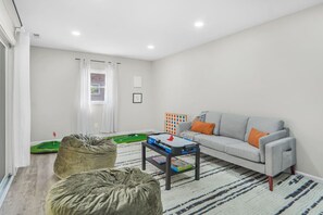 Spacious game room with comfortable seating and plenty of space to unwind or have fun with friends and family.