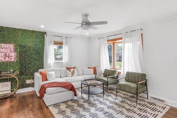 Bright and inviting living space with cozy seating, stylish decor, and plenty of natural light — perfect for relaxing with family or friends.
