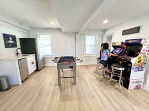 Play arcade games or foosball in the game area equipped with a fridge, ice maker, and 40" ROKU TV!