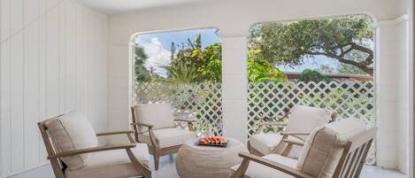 The screened lanai has 4 soft & cushy teak chairs.  Enjoy a glass of wine with friends