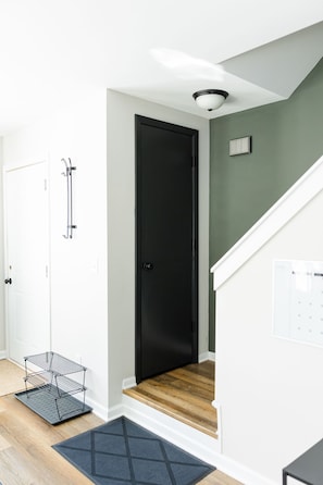 Front entrance and stairs up to second floor. Coat closet on stair landing. 