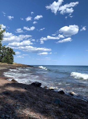 Level ledge rock and cobblestone beach on a quiet cove.