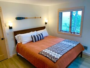Lower level bedroom with Cal King bed, lake views, and private exit to beach
