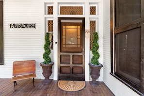 The original screen door and hand carved front door welcome you into the home.