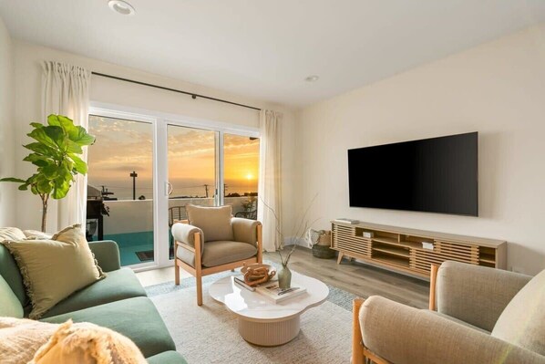 Step into our cozy living room, where warm sunlight floods in, casting a golden glow across the space