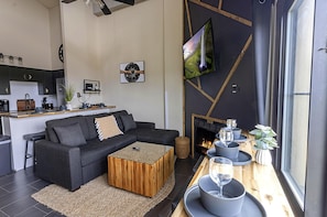 The living room area is the perfect place to kick back and offers additional sleeping capacity.