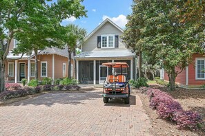 Front of Bungalo with 6 seater golf cart