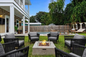 Grill up a feast on the BBQ, relax on comfy loungers, and enjoy a fire pit under the stars in the expansive outdoor space. - The Sandbar - Panama City Beach, FL