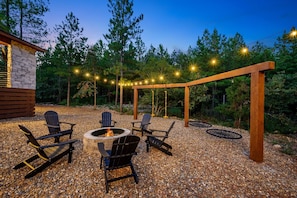 Backyard—swing set, fire pit, chairs, lighting and lots of graveled space.