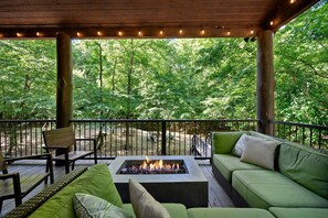 The covered deck with a gas firepit.