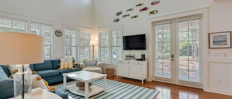 There is a lot of natural light that comes in through the windows and doors in this gorgeous living room.