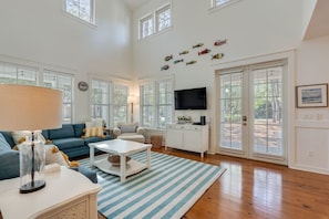 There is a lot of natural light that comes in through the windows and doors in this gorgeous living room.