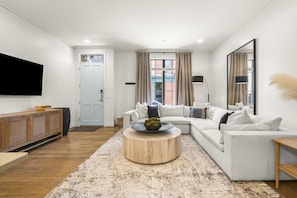 StayRepublic | Living Room w/ Smart TV (Plenty of Seating!) Open to Kitchen, Dining & Half Bathroom.