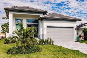 A walkway links the driveway to the front door so guests can enter with ease. | Brisa del Mar by Boutiq Luxury Vacation Rentals | Naples, Florida
