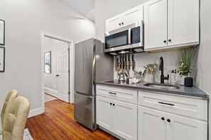 The kitchen is equipped with basic appliances for a more convenient stay.