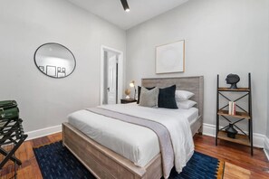 The bedroom offers a cozy queen-size bed and includes two luggage holders for your convenience.