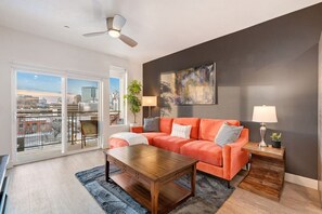 Gorgeous Livingroom, 65" TV, Comfy colorful couch. Beautiful views off your patio.