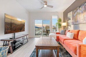 Gorgeous Livingroom, 65" TV, Comfy colorful couch. Beautiful views off your patio.
