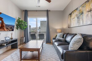 Relax and recharge in this highly designed  space featuring a luxury couch and local art!