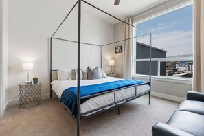 King size bed in a highly designed space with local art.