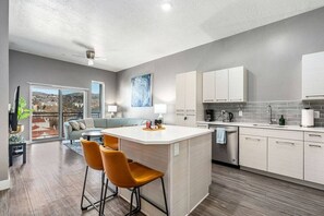 Open plan kitchen/living room with large picture windows and  amazing views