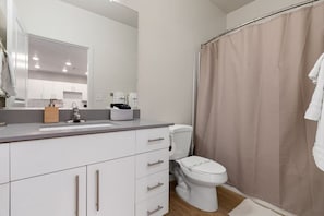 Plenty of soft new towels, a hairdryer, and straightening iron in the ultra-clean bathroom.