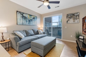 Large Comfy Sleeper Sofa with Ottoman. A highly designed space with local art.
