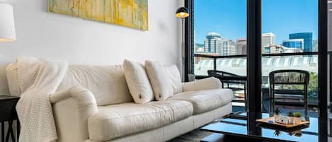 Luxury leather sofa and local art with a city view!