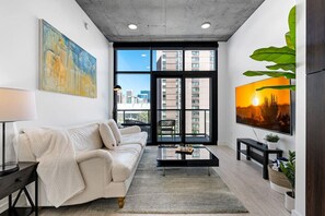 Relax with a luxury leather sofa, a 65 HD TV and a lovely deck with a view!
