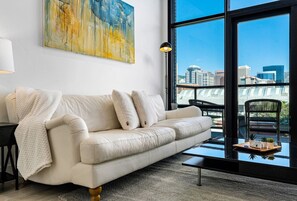 Luxury leather sofa and local art. Amazing views from the ceiling to floor windows and off the patio!