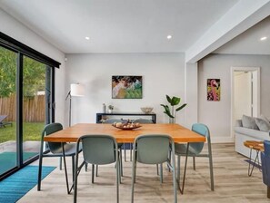 The spacious and light-filled dining room with pool views seats 6-8 guests.