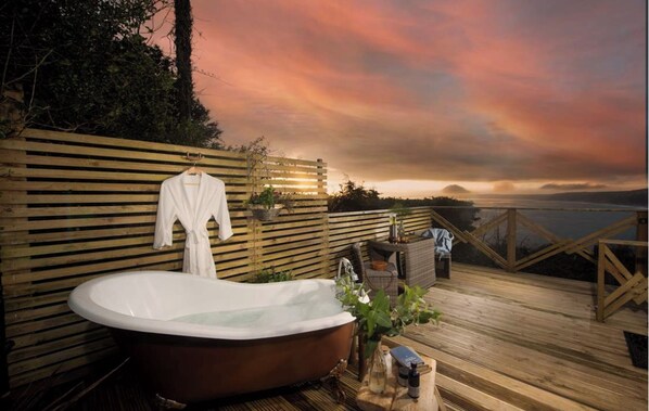 heated cast iron outdoor bath/hot tub overlooking whitsand bay