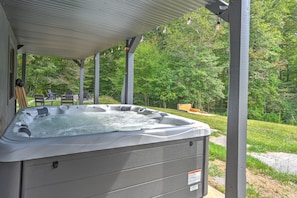 Hot tub is covered so it can be used in all weather.