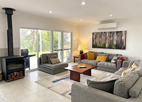 Spacious main lounge room with wood fire and huge comfy couches.