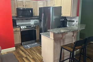 Fully equipped kitchen with stainless steal appliances, pots and utensils  