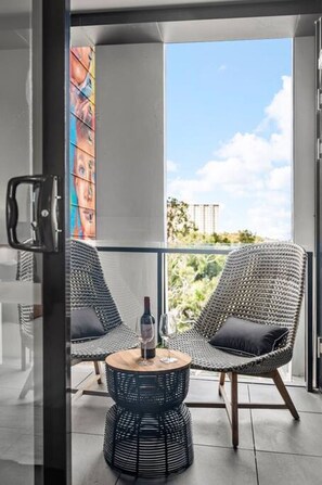 Enjoy a drink on your private balcony with great skyline views
