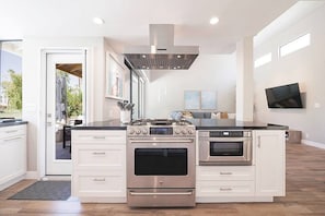 The fully stocked kitchen is a chef's delight, boasting top-of-the-line appliances