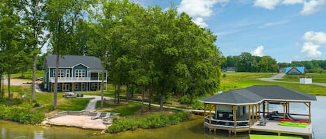 Your family will enjoy our large private lakefront lot with 250' of waterfront property, a private sandy beach, amazing private dock and boat house with a tiki bar, comfy lounge area for relaxing, and all the fun water toys!