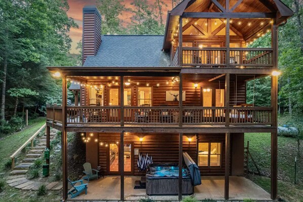 The wraparound porch offers breathtaking views of the surrounding forest.