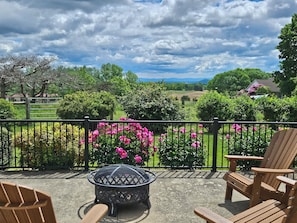 Early Summer view with bright pink peonies and vibrant blue mountain views!