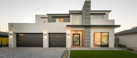 Modern home w/ large driveway & windows allowing lots of natural light in 