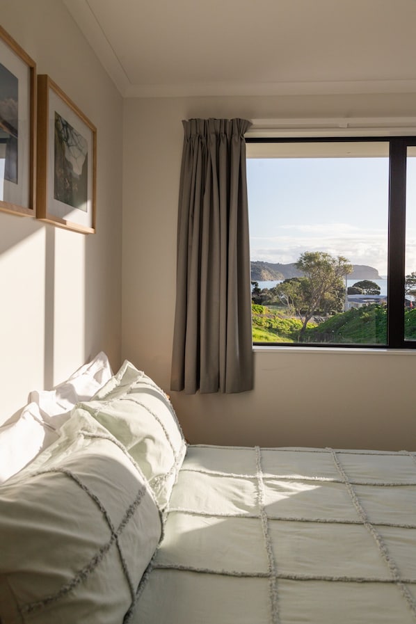 Primary bedroom with views of the Hokianga Harbour