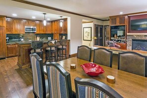 Separate dining area with a large table for six. Extra seating provided at the kitchen counter.