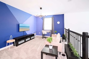 Loft TV lounge with dedicated workstation