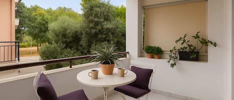 Peaceful Balcony Retreat with Lush Green Views, Plum Cushions, and Morning Coffee Setup