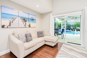 Family room with a sleeper sofa and pool view