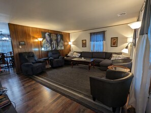 very spacious living room with two rocker recliners and two reading chairs 