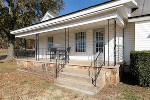 A few stairs lead to the front porch and the front door.