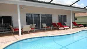 Dining area and lounge chairs can be found on the covered patio